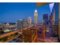 Relax on this balcony with a cozy table and chairs with stunning views of the downtown skyline at 333 W Trade St # 2704, Charlotte, NC 28202