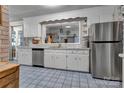 Bright kitchen with white cabinets, stainless steel appliances, and a unique window above the sink at 3609 Southwood Dr, Gastonia, NC 28056