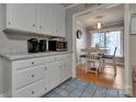 Cozy kitchen featuring white cabinets, dining area and great natural light at 3609 Southwood Dr, Gastonia, NC 28056