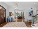 Elegant foyer boasts hardwood floors, chandelier, and views into the dining room at 3925 Silver Bell Dr, Charlotte, NC 28211