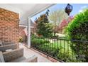 Inviting covered porch with seating area overlooking the manicured front yard at 3934 Blue Dory Ln, Denver, NC 28037