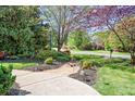 Manicured front yard featuring landscaped beds and a stone walkway leading to the house at 3934 Blue Dory Ln, Denver, NC 28037