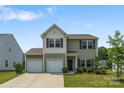 Charming two-story home featuring a two-car garage, neutral siding, and well-maintained landscaping at 4213 Stockbrook Dr, Charlotte, NC 28215