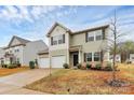 Two-story home featuring a well-maintained yard, a convenient two-car garage, and beautiful landscaping at 4213 Stockbrook Dr, Charlotte, NC 28215