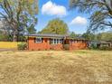 Charming brick home with mature trees, manicured landscaping, and a well-maintained front yard at 4331 Hamilton Cir, Charlotte, NC 28216