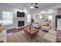 Bright living room featuring a fireplace, hardwood floors, and comfortable seating at 5670 Hammermill Dr, Harrisburg, NC 28075
