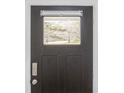 Stylish black front door featuring glass panel, hardware, and a modern door lock at 5962 Charlie Walker Rd, Kannapolis, NC 28081