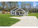 Home exterior featuring a wide driveway leading to the house with a well-maintained lawn at 5962 Charlie Walker Rd, Kannapolis, NC 28081