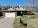 Beautiful home with a two-car garage, landscaped front yard, and brick facade at 7283 Bradberry Ln, Denver, NC 28037