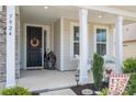 Warm and welcoming front entrance with decorative wreath, charming statues, and elegant architectural details at 7924 Creek Park Dr, Denver, NC 28037