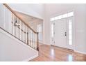 Bright entryway with hardwood floors, staircase, and a front door with sidelights at 8004 Talcott Dr, Mint Hill, NC 28227