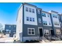 Contemporary townhome with blue and gray facade, modern windows, and low-maintenance landscaping at 8010 Elevate Ct, Charlotte, NC 28205