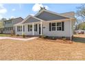 Stylish home boasts light gray siding, dark shutters, and meticulously maintained landscaping at 816 S Confederate Ave, Rock Hill, SC 29730