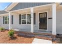 Welcoming front porch with classic columns, brick accents, and a freshly painted door at 816 S Confederate Ave, Rock Hill, SC 29730