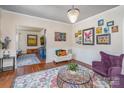 Bright living area featuring hardwood floors, a decorative rug, and artistic wall decor at 820 N Main St, Salisbury, NC 28144