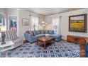 Cozy living room with comfortable seating, a patterned rug, and natural light from surrounding windows at 820 N Main St, Salisbury, NC 28144