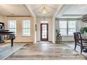 Bright foyer features hardwood floors, elegant lighting, and a grand piano at 822 Flatwater Ct, Fort Mill, SC 29708