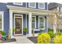 Inviting front porch with modern seating and stylish accents enhances the curb appeal at 822 Flatwater Ct, Fort Mill, SC 29708