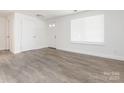 Bright living room featuring hardwood floors and modern design, with a window at 8432 Strider Dr, Charlotte, NC 28212