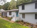 Two story home with manicured landscaping, a grey roof, dark accents and a vibrant blue front door at 105 Timber Ridge Rd, Belmont, NC 28012