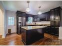 Modern kitchen featuring granite countertops, stainless steel appliances, and dark cabinets at 105 Timber Ridge Rd, Belmont, NC 28012