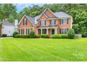 Charming brick home with manicured lawn and landscaping, showing curb appeal and a welcoming entrance at 1102 High Brook Dr, Waxhaw, NC 28173