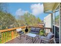 Relaxing outdoor deck area with comfortable seating and scenic backyard views at 11615 Hidden Grove Trl, Charlotte, NC 28215