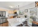 Modern kitchen featuring stainless steel appliances, granite counters, and ample natural light at 11615 Hidden Grove Trl, Charlotte, NC 28215