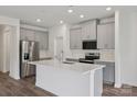 Modern kitchen featuring gray cabinets, stainless steel appliances, a central island with white countertop, and stylish backsplash at 1234 Morehead Dr, Salisbury, NC 28144