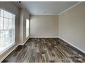 Bedroom with laminate floors, large windows, and neutral paint at 1240 Periwinkle Dr, Waxhaw, NC 28173