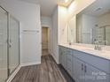 En-suite bathroom features a double sink vanity, sleek fixtures, and a glass-enclosed shower stall at 1247 Morehead Dr, Salisbury, NC 28144