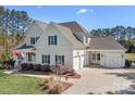 Side view of a charming two-story home with a three car garage at 127 Castle Dr, Mooresville, NC 28117