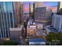 A stunning aerial perspective highlighting the building's place in the city's urban landscape at dusk at 127 N Tryon St # 615, Charlotte, NC 28202