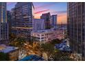 A captivating dusk aerial view capturing the building's position in the city skyline and vibrant cityscape at 127 N Tryon St # 615, Charlotte, NC 28202