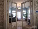 Bright office space with large windows, hardwood floors, and glass doors at 146 Saluda St, Chester, SC 29706