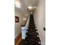Charming staircase with a floral carpet runner and wooden banister at 146 Saluda St, Chester, SC 29706