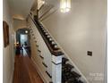 Elegant staircase with a patterned carpet runner and hardwood flooring at 146 Saluda St, Chester, SC 29706