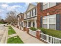 Attractive townhome showcasing brick accents, black shutters, a covered porch and well-maintained landscaping at 1720 Chamberside Dr, Rock Hill, SC 29730