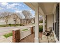 Cozy front porch with seating, showcasing the brick and picket fence details and neighborhood view at 1720 Chamberside Dr, Rock Hill, SC 29730