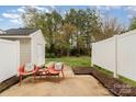 Relaxing outdoor patio with seating, perfect for enjoying the backyard and landscaped surroundings at 1720 Chamberside Dr, Rock Hill, SC 29730