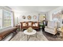 Comfortable living room featuring a plush rug, stylish seating, and natural light from large windows at 2011 Dunsmore Ln # 137, Waxhaw, NC 28173