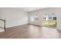 Bright, open living room with wood floors and sliding door to the backyard at 2070 Old Rivers Rd, Concord, NC 28027