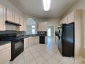 Well-equipped kitchen featuring tile floors, modern appliances, and ample cabinetry at 2122 Shumard Cir, Indian Trail, NC 28079