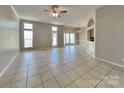 Open-concept living room boasts tile floors, bright windows, and elegant lighting at 2122 Shumard Cir, Indian Trail, NC 28079
