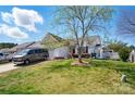 Well-manicured lawn and landscaping enhance the curb appeal of this lovely home, featuring mature shade trees at 2425 Barkers Ridge Dr, Bessemer City, NC 28016