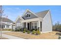 Charming two-story home featuring stone accents, a covered porch, and a well-manicured lawn at 2768 Suffolk Pl, Fort Mill, SC 29715