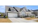 Charming two-story home featuring stone accents, a covered porch, and a well-manicured lawn and two-car garage at 2768 Suffolk Pl, Fort Mill, SC 29715