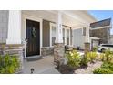 Covered front porch with stone columns, seating area, and stylish front door wreath at 2768 Suffolk Pl, Fort Mill, SC 29715