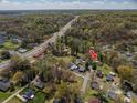 Aerial view of neighborhood featuring this charming home and surrounding trees at 300 Bell St # 80, Mount Holly, NC 28120