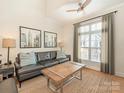 Comfortable living room featuring a ceiling fan, large window, and stylish furnishings at 301 E Tremont Ave, Charlotte, NC 28203